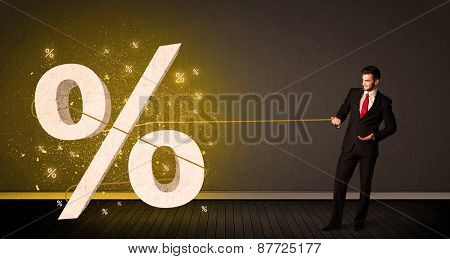 Business man pulling rope with big procent symbol sign concept on background