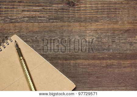 Notepad With Gold Fountain Pen On The Old Wood Table