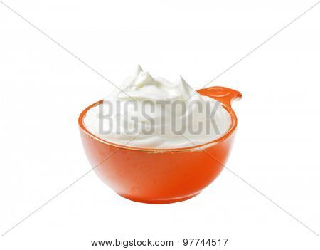 creme fraiche in an orange bowl isolated on white