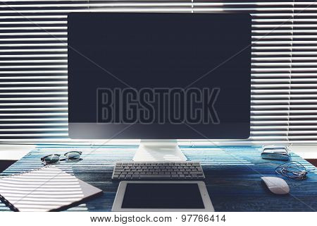 Blank screen pc on workspace with accessories and work tools