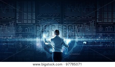 Back view of businesswoman working with modern virtual technologies