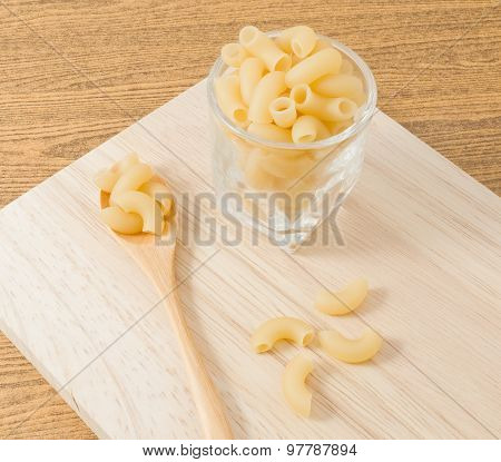 Elbow Macaroni Or Gomiti Pasta On Wooden Cutting Board