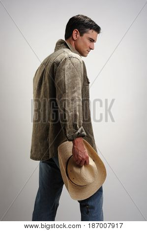 The tough cowboy pears down at the floor.