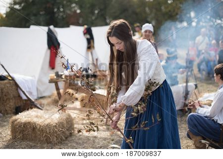 01 October 2016. A historical reenactment of the Wars History in Kiev, Ukraine. An installation of Napoleon Army camp, a French laundress girl collecting brushwood.