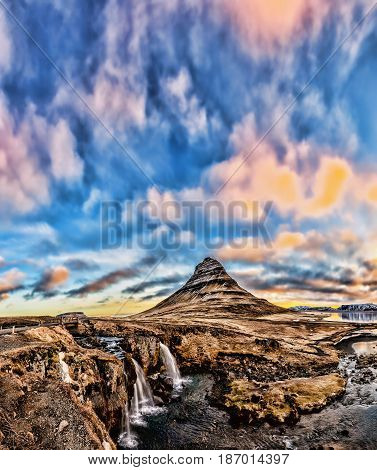 Spring Sunrise Over The Famous Kirkjufellsfoss Waterfall With Kirkjufell Mountain In The Background