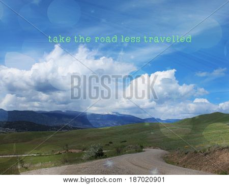 Conceptual landscape view with inspirational quote. Take the road less travelled. Lighting effects.