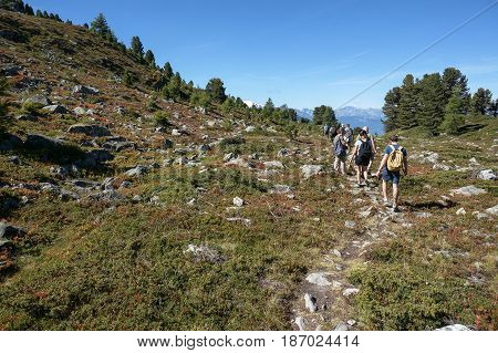 Tourist walking along trekking trail in Nendaz, Switzerland