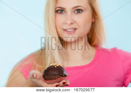 Woman Holding Chocolate Cupcake About To Bite