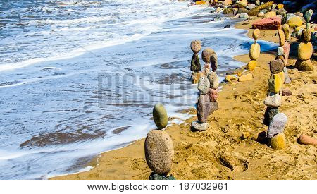 Stacked rocks on seashore in the sand