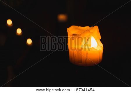 One candle flame at night closeup - isolated, macro.