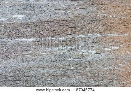 Aged weathered and peeling paint surface background on a board.
