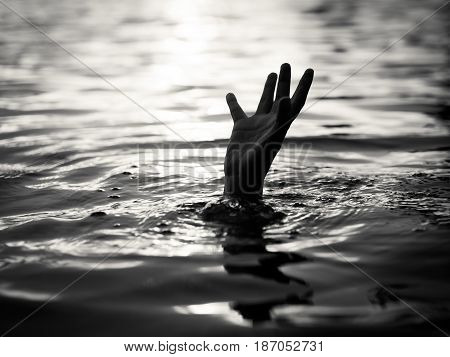 Black and white of Drowning victims Hand of drowning man needing help. Failure and rescue concept.