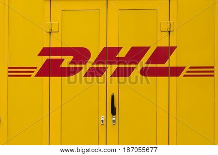 BErlin Germany - may 16 2017: DHL logo on delivery truck car door. DHL is the global market leader in logistics industry.