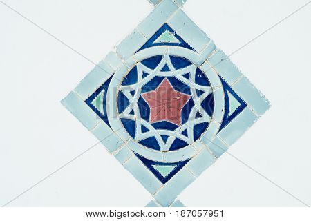 The colorful geometric patterns of an Islamic mosaic decorating the walls of the Kasbah Telouet, a semi-ruined palace fortress in Morocco's Atlas Mountains.