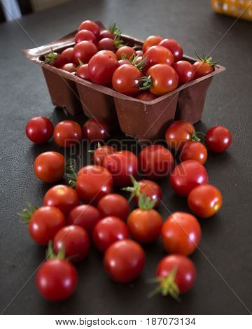 Red tomatoes splayed out upon a table