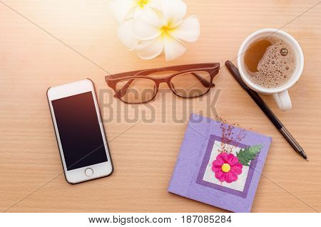 sunrise office with wooden table and laying on it with coffie