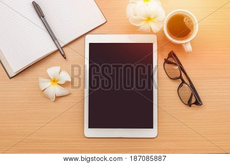 sunrise office with wooden table and laying on it with coffie