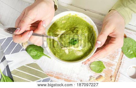 Young Woman Hands With Bowl Of Green Spinash Soup.