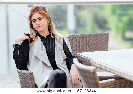 Woman Sit Near The Table Hold Her Glasses