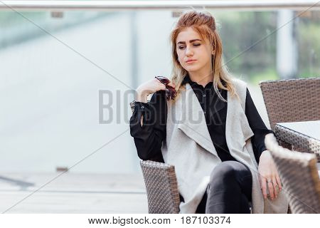 Woman Sit Near The Table Hold Her Glasses