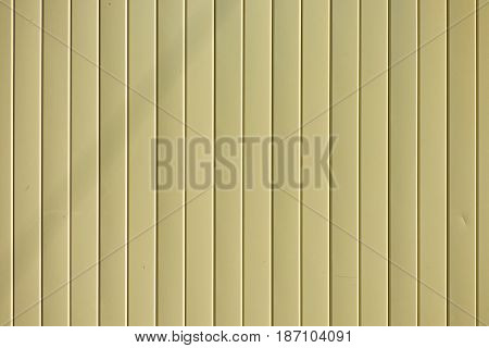 Light yellow goffered metal texture, corrugated steel surface. Industrial background.