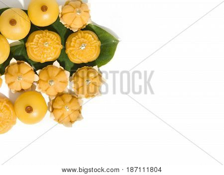 Sweet yellow dessert royal Thai cuisine decorated with green leaf on solid white background