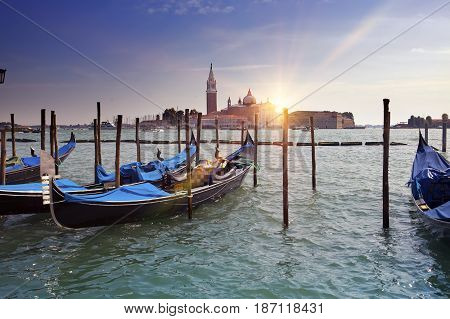 Venice. A sunset over the channel Grande and gondolas at the mooring