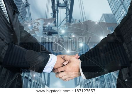 Double Exposure of a businessman handshake with Map global partner connection of Container Cargo freight ship for Logistic Import Export background (Elements of this image furnished by NASA)