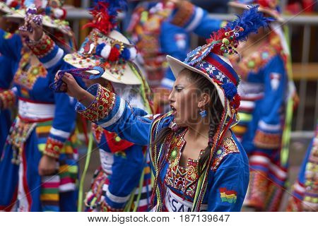 ORURO, BOLIVIA - FEBRUARY 26, 2017: Tinkus dance group in ornate costumes performing as they parade through the mining city of Oruro on the Altiplano of Bolivia during the annual carnival.