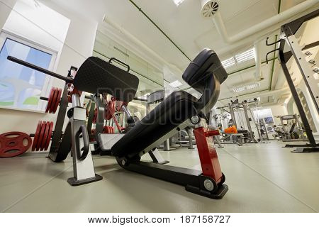 Diagonal leg press training machine in gym room.