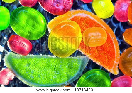 Delicious background, multicolored lollipops and slices of marmalade , top view