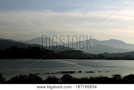 Mountains in the distance with a lake in front.