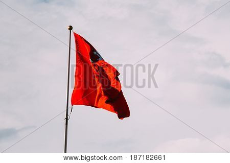 Coat Of Arms Of Lithuania On The State Historical Flag Of Lithuania, Waving On Flagpole At Sky Background.