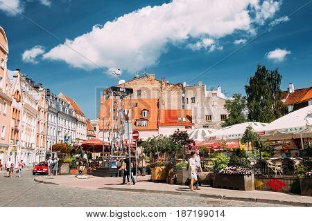 Riga, Latvia - July 2, 2016: People Walking Near Open Air Leisure Venue Recreation Center Egle In Sunny Day In Old Town On Kalku Street.