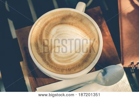 A cup of coffee with a heart on the foam