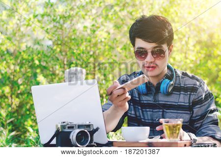 Young businessman working on laptop at garden.