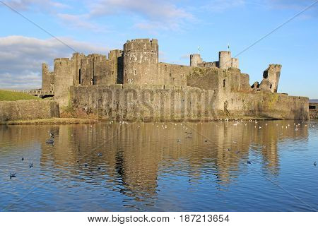 Caerphilly castle reflected in a lake, Wales