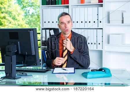 Business Man Behind His Desk In Summerly Hot Office
