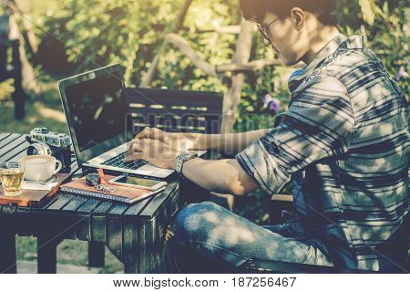 Young businessman working on laptop at garden.