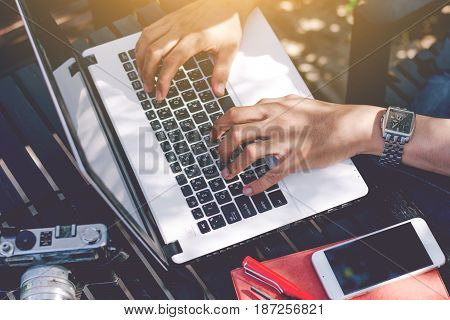 Young businessman working on laptop at garden.