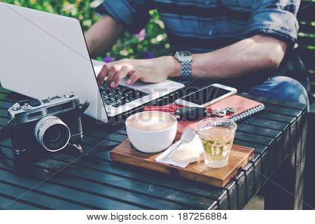Young businessman working on laptop at garden.