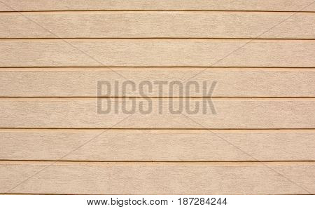 The wall is beige orange. Plaster, vertical stripes. Textured Background With Abstract Relief Pattern. Example of finishing concrete walls