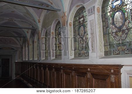 Italy Florence - December 24 2016: the view of the stained glass with scenes from the life of Saint Benedict in the colloquium corridor inside Florence Charterhouse church. Certosa di Galluzzo di Firenze on December 24 2016 in Florence Tuscany Italy.
