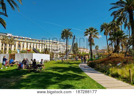 People Walking And Relaxing In Albert I Gardens