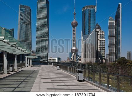 Empty road marble floor of footbridge with city landmark office buildings backgrounds
