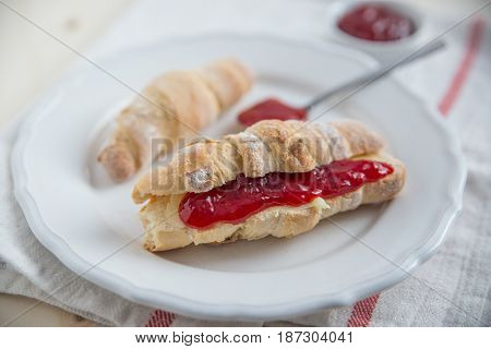 Fresh tasty homemade croissants with home made raspberries jam