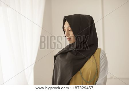 Portrait of a modest Muslim woman on a light background Russia