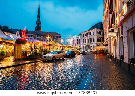 Riga, Latvia - July 3, 2016: Sedan Car BMW 5 Series E39 Parking Near Open Air Leisure Venue Recreation Center Egle In Evening Or Night Illumination In Old Town On Kalku Street
