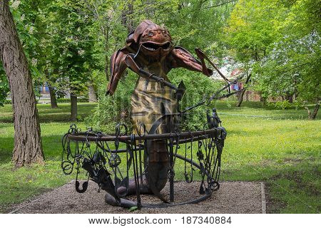 Donetsk Ukraine - May 09 2017: Iron statue of a beetle near an anvil in a park of forged figures