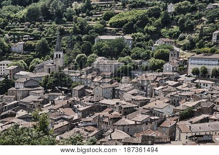 Roofs of houses and medieval castle in Largentiere France